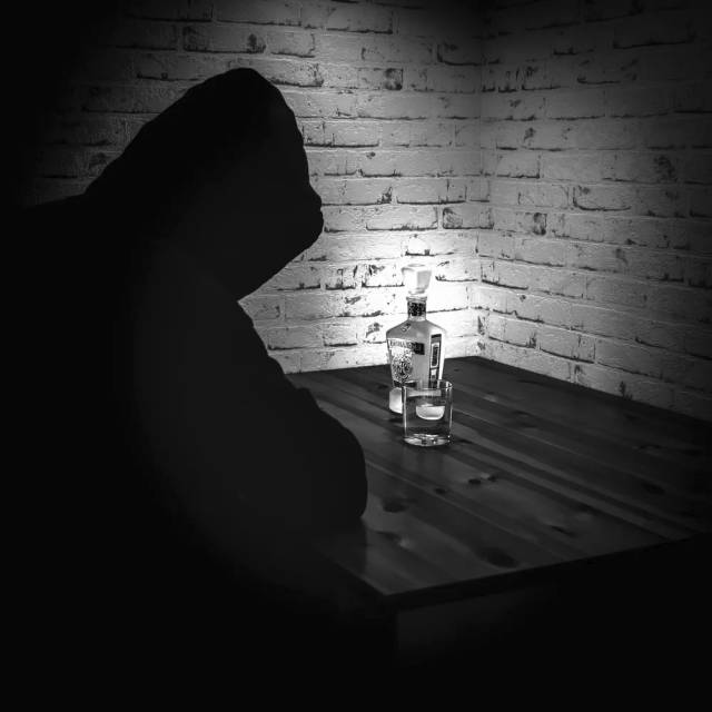 Mensch an einem Tisch im Dunkeln