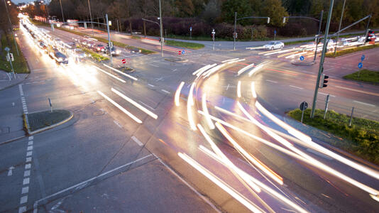 Langzeitbelichtung einer Straßenkreuzung mit Lichtspuren