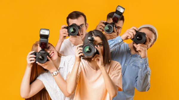 Group,Of,Photographers,On,Color,Background