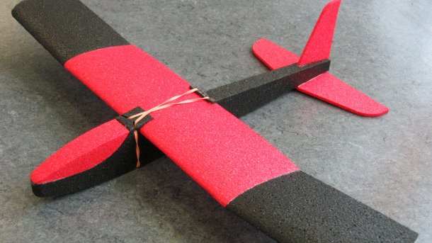 schwarz-roter Wurfgleiter in Form eines Flugzeugs