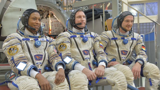 Drei Raumfahrer in Raumanzügen posieren für Foto