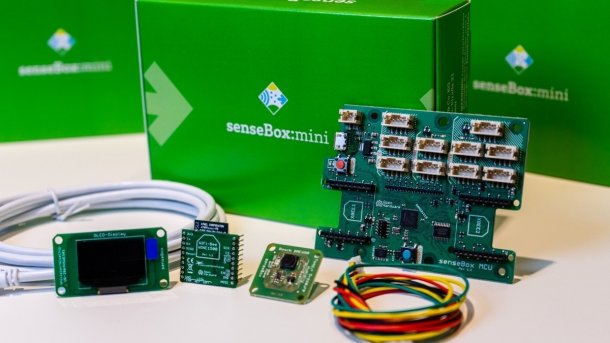 Eine grüne Kiste, davor mehrere Elektronikteile.