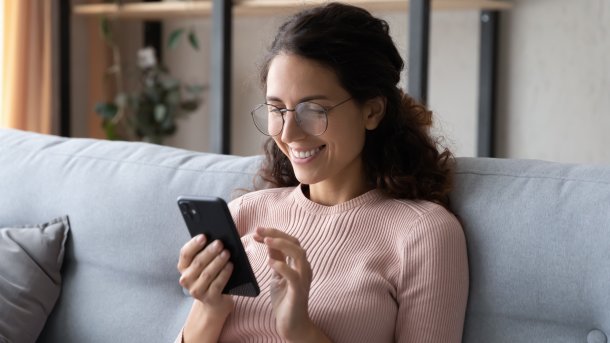 Happy,Millennial,Woman,Relaxing,On,Comfortable,Sofa,,Enjoying,Web,Surfing