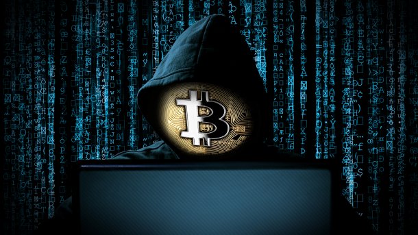 Hacker,With,Bitcoin,Face,Mask,Behind,Notebook,Laptop,In,Front,Crypto,Kryptowährung