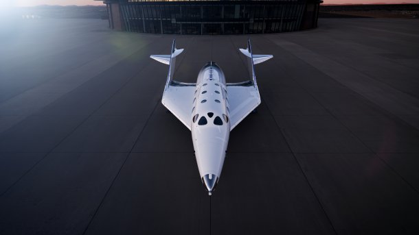 Ein Virgin-Galactic-Raumgleiter steht vor einem Hangar