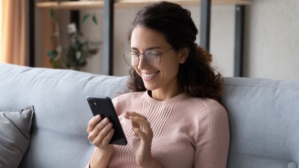 Happy,Millennial,Woman,Relaxing,On,Comfortable,Sofa,,Enjoying,Web,Surfing