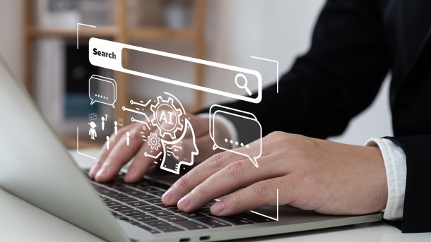 Typing hands, with symbols and the letters AI floating above them. 