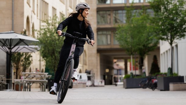 Woman happily riding her e-bike.
