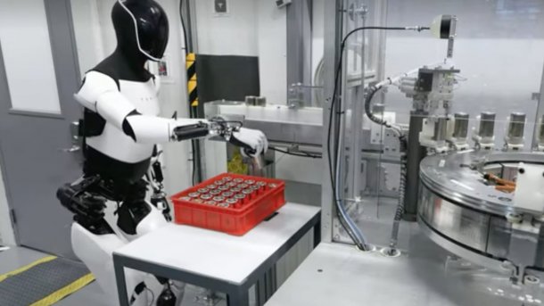 Tesla Optimus sorts battery cells into a box.