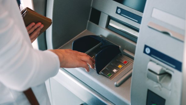 A person operates an ATM