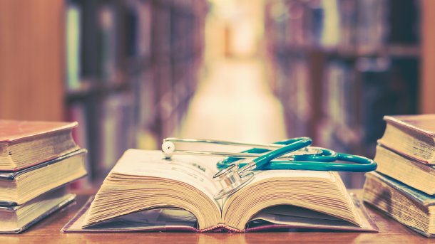 Library with an open book containing a stethoscope.