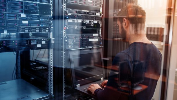 Young man at a server cabinet