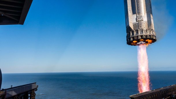 Missile with burning engines near the launch pad