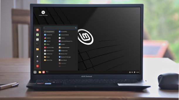 Linux Mint 22.1 desktop on notebook on table