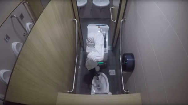 Hytron cleaning robot cleans a toilet.