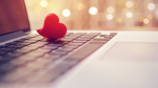 Red heart lies on notebook keyboard