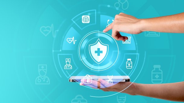 Futuristic symbols from the field of medicine lie on a flat hand. The other hand points to one of the symbols from above.