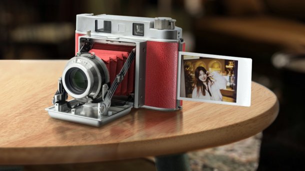 The new TTArtisan 203T instant camera stands on a wooden table.