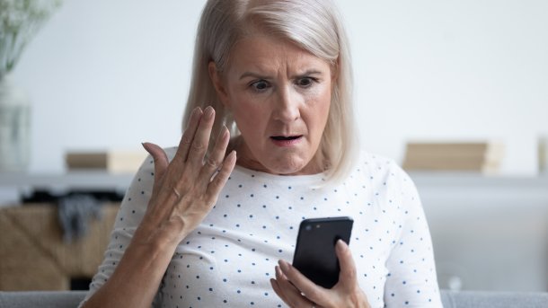 A woman is annoyed by her cell phone