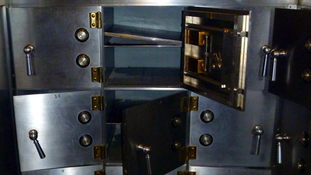 Several large safe deposit boxes, some of which are open and empty