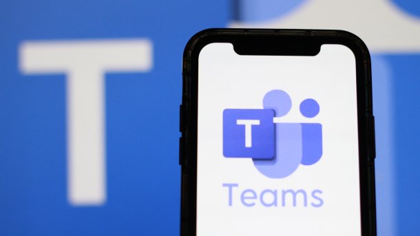 The Microsoft Teams logo is displayed on a smartphone screen.