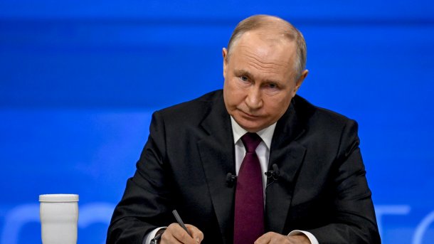 Vladimir Putin with pen in hand