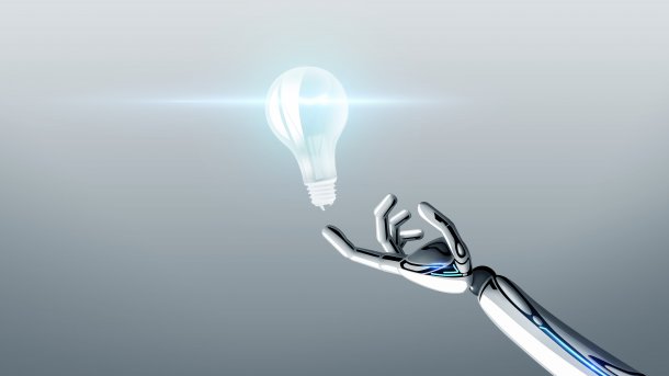 Robot arm holds a light bulb with its index finger