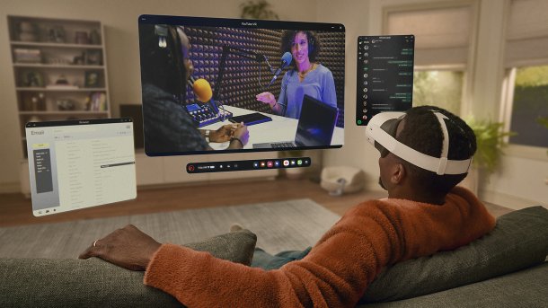 Rear view: person with VR glasses on sofa, multitasking with YouTube VR, e-mail and WhatsApp on floating displays.