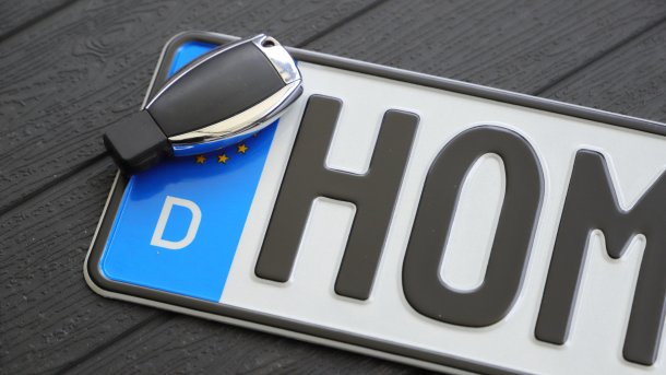 License plate with key lying on table
