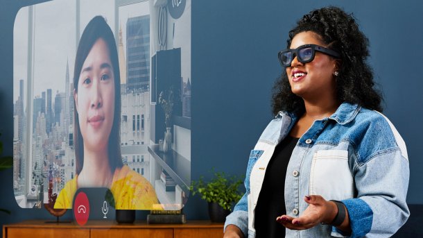 Woman with Orion AR glasses holds video conference with conversation partner.