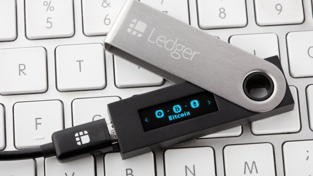A Ledger Stick is placed on a PC keyboard