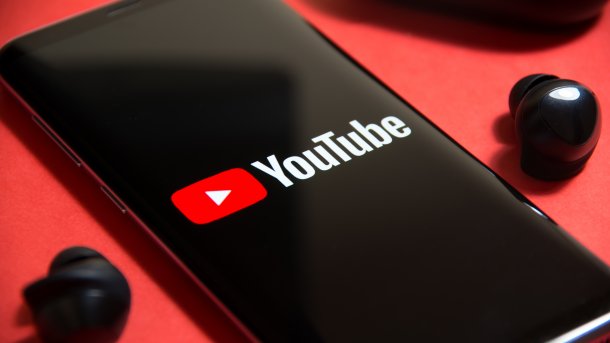 The YouTube app is displayed on a smartphone.