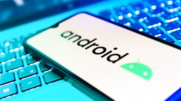 Cell phone with Android lettering lies on laptop keyboard