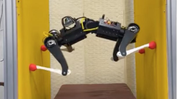 Robot dog supports itself with its legs between two walls.