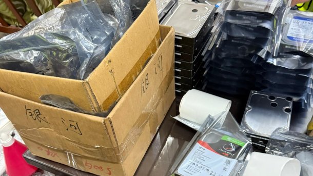 Stack of hard disks on a table, partly in a box