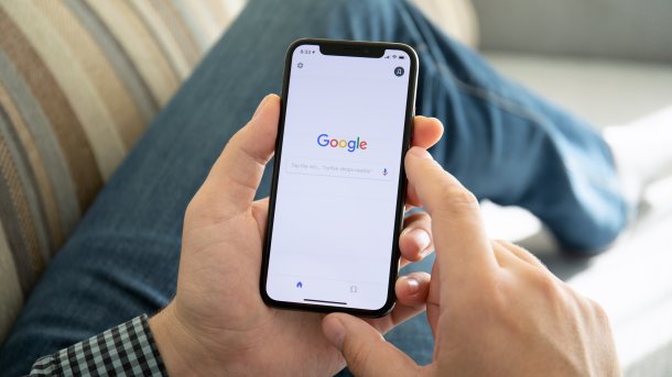 Person uses Google search on an iPhone