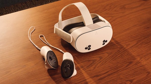 Meta Quest 3S with Touch Plus controllers lies on a wooden table.