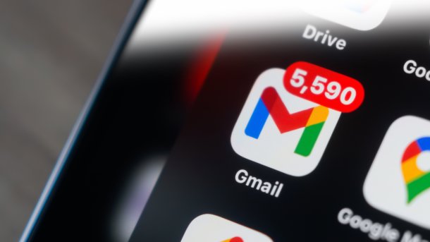 The Gmail logo on a smartphone, here with 5590 notifications