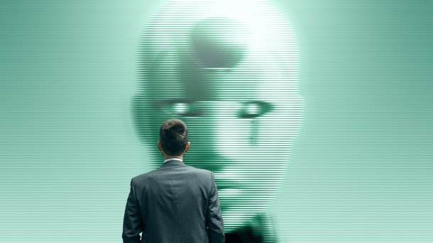 Businessman,Staring,At,A,Humanoid,Ai,Robot,On,A,Screen,