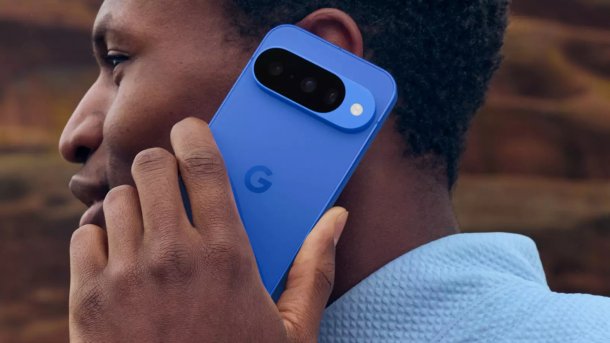 Blue Google Pixel 10 on a man's ear