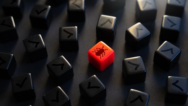 Lots of black cubes. In the middle is a red cube with a beetle on it.