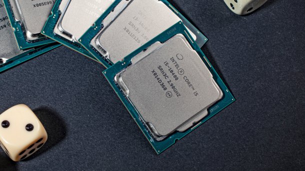 Five processors on a table next to dice