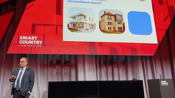 Photo of Kim Nguyen in front of presentation slide