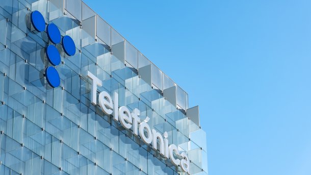 Detail of the glass facade with company logo at the headquarters of the Telefónica Group in Madrid.