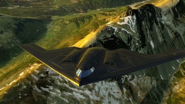 A futuristic stealth bomber flies in Flight Unlimited over a detailed mountain landscape with snow-capped peaks and green valleys. The scene shows realistic lighting and shadow effects in a VR environment.