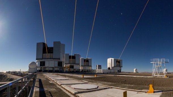 Four telescopes, with a laser pointing into the sky from each.