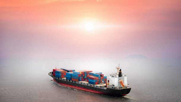 Container,Ship,In,The,Ocean,At,Sunset,Sky,Background,With