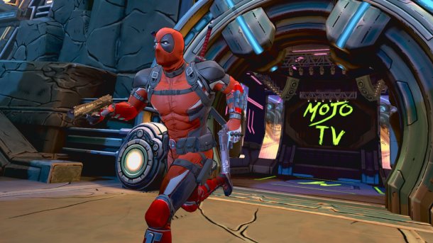Deadpool sprints through a futuristic arena in Marvel’s Deadpool VR with his pistol drawn, the glowing logo of Mojo TV in the background.