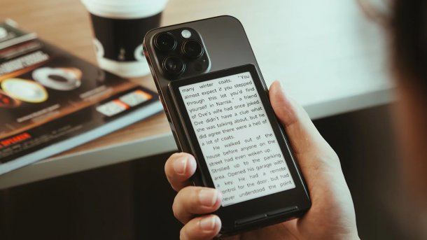 Man holds an e-book reader in his hand