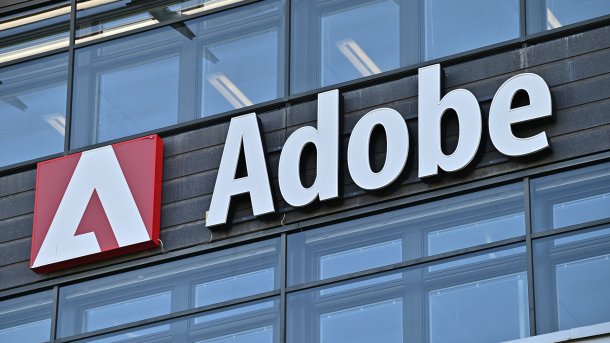 A wall sign for the American software company Adobe on an office building.